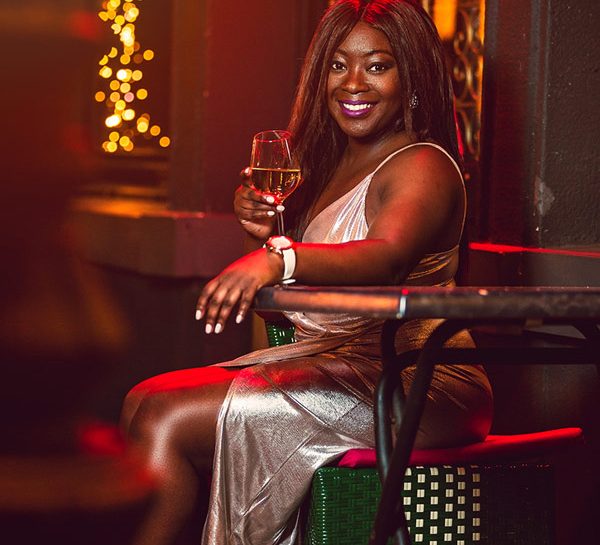 woman in silver night dress surrounded with warm night lights